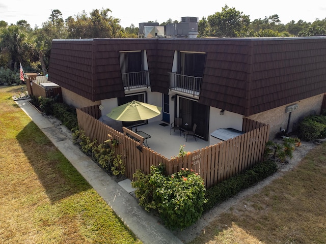 rear view of property with a lawn