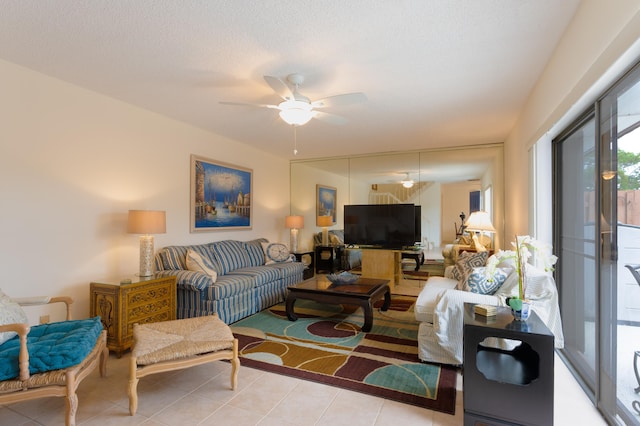 tiled living room with a textured ceiling and ceiling fan