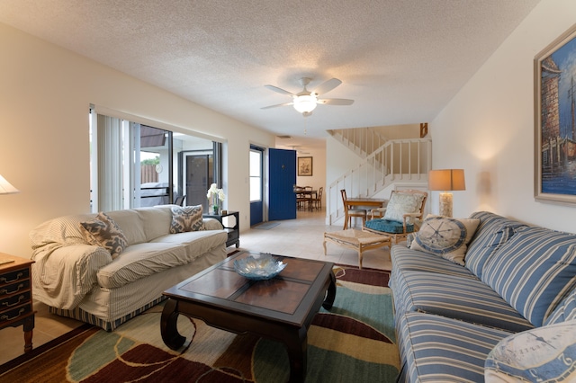 living room featuring a textured ceiling and ceiling fan