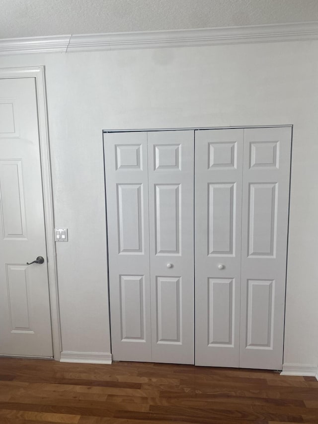 interior details featuring hardwood / wood-style floors and crown molding