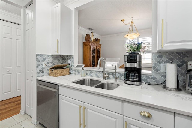 kitchen with decorative backsplash, sink, decorative light fixtures, dishwasher, and white cabinetry