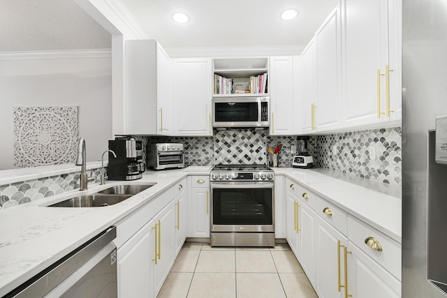 kitchen featuring light stone countertops, sink, light tile patterned floors, and stainless steel appliances