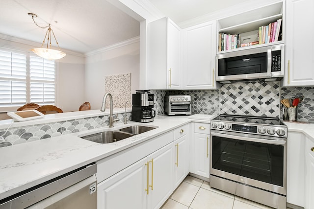 kitchen with sink, light tile patterned floors, pendant lighting, white cabinets, and appliances with stainless steel finishes