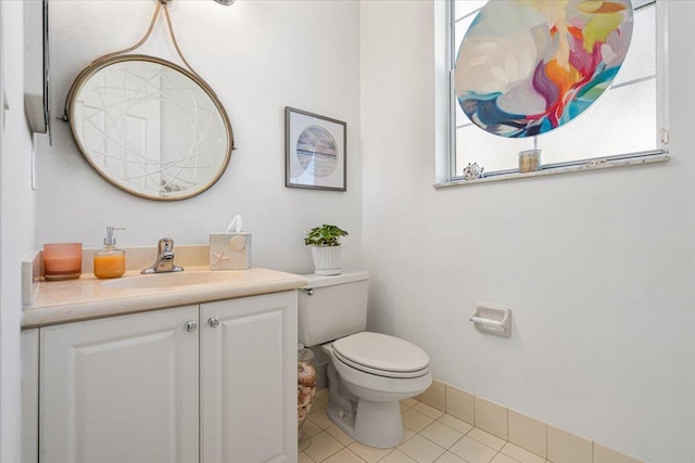 bathroom with tile patterned flooring, vanity, and toilet