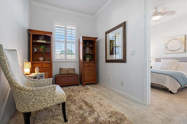 sitting room featuring ceiling fan, ornamental molding, and light carpet