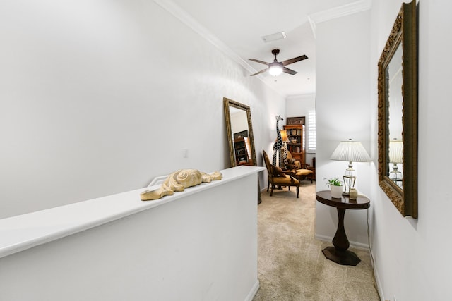 corridor with crown molding and light carpet