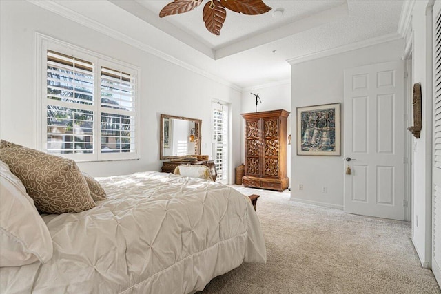 bedroom with carpet, a textured ceiling, ceiling fan, and crown molding