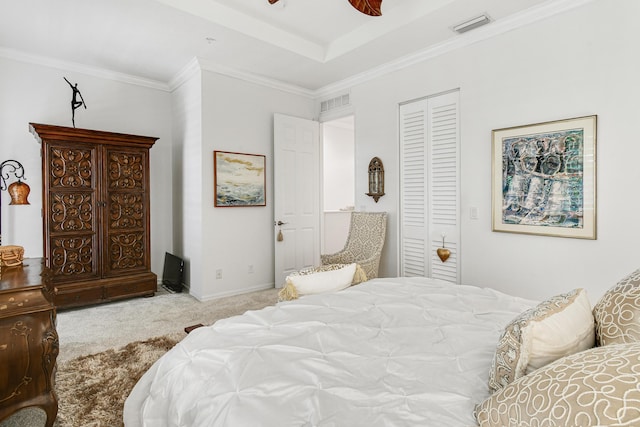 carpeted bedroom with crown molding, a closet, and ceiling fan