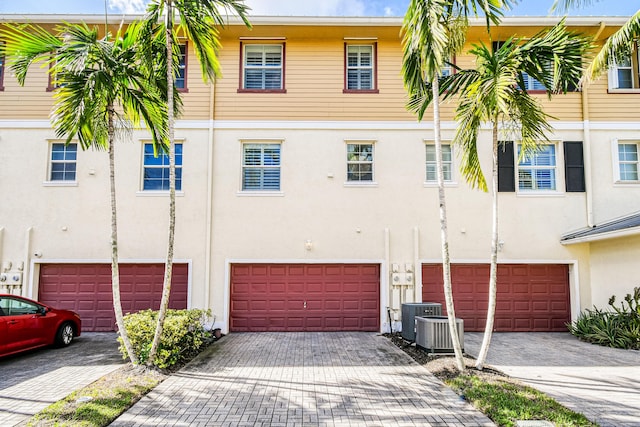 view of property with central AC and a garage