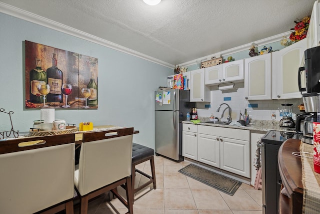 kitchen with stainless steel appliances, white cabinetry, ornamental molding, and sink