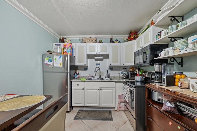 kitchen featuring ornamental molding, a textured ceiling, stainless steel appliances, sink, and white cabinetry