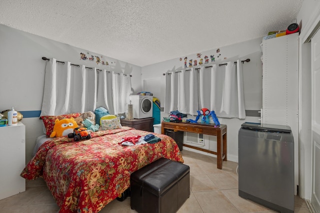 bedroom featuring stainless steel refrigerator, light tile patterned floors, and a textured ceiling