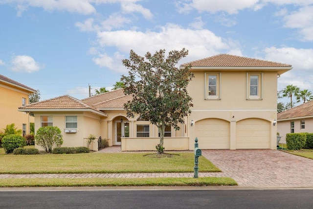 mediterranean / spanish-style home featuring a front yard and a garage