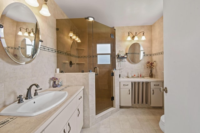 bathroom featuring vanity, tile patterned floors, tile walls, tasteful backsplash, and an enclosed shower