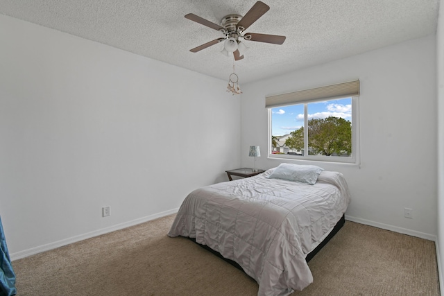 bedroom featuring carpet, a textured ceiling, and ceiling fan