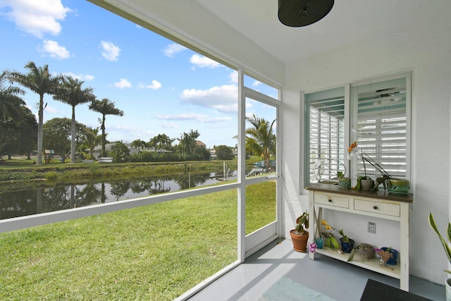 sunroom / solarium with a water view