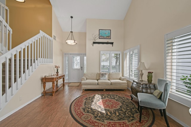 living room featuring hardwood / wood-style floors and high vaulted ceiling