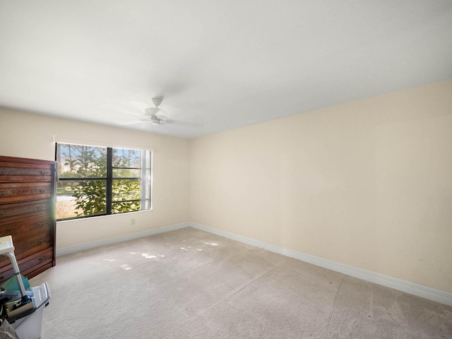 carpeted empty room with ceiling fan