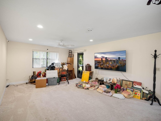 rec room featuring light carpet and ceiling fan