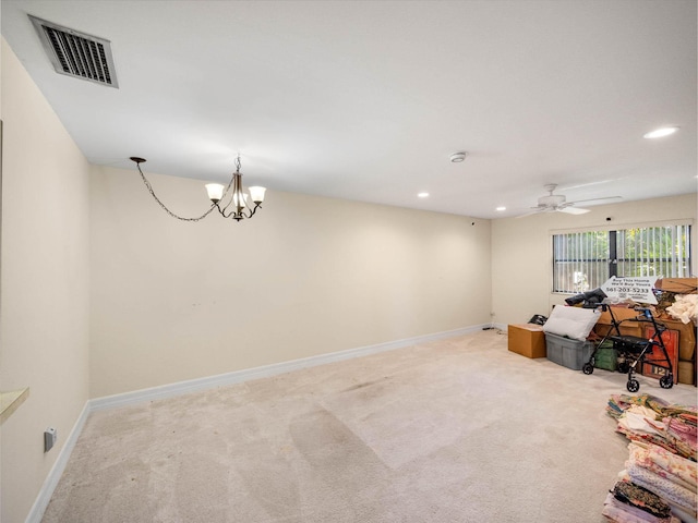 interior space with light carpet and ceiling fan with notable chandelier