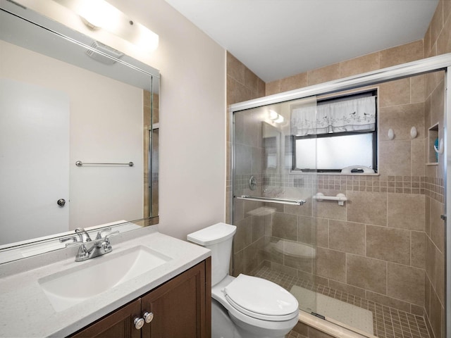 bathroom with vanity, an enclosed shower, and toilet