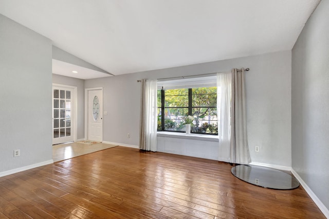 interior space with hardwood / wood-style flooring and lofted ceiling