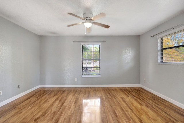 empty room featuring ceiling fan and light hardwood / wood-style flooring