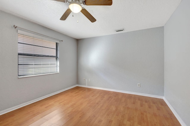 spare room featuring hardwood / wood-style floors and ceiling fan