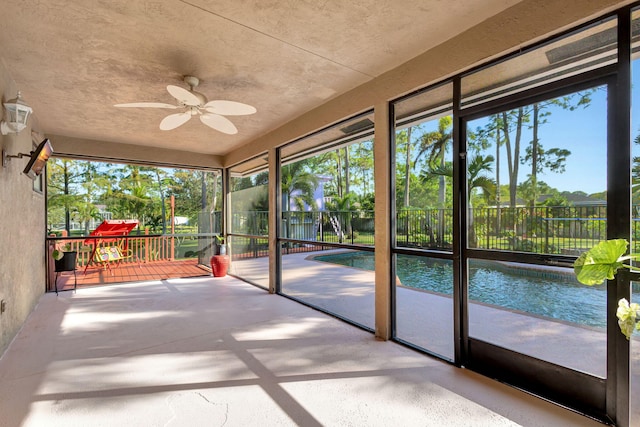 unfurnished sunroom with plenty of natural light and ceiling fan