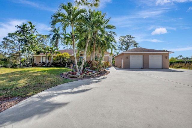 single story home with a garage and a front lawn