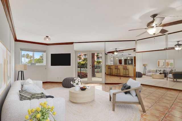 tiled living room with crown molding and french doors