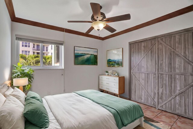 tiled bedroom featuring ceiling fan and ornamental molding