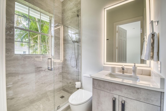 bathroom featuring vanity, toilet, and a shower with shower door