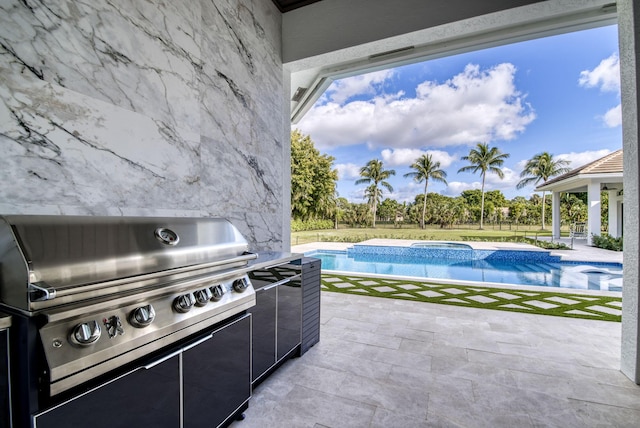 view of patio / terrace featuring area for grilling and a swimming pool with hot tub