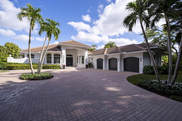 mediterranean / spanish home with a garage