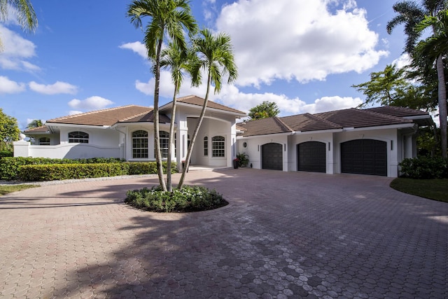 mediterranean / spanish-style house with a garage