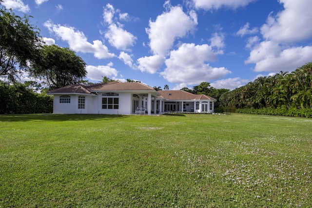 rear view of house with a yard