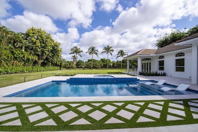 view of swimming pool featuring a lawn, a patio area, and an in ground hot tub