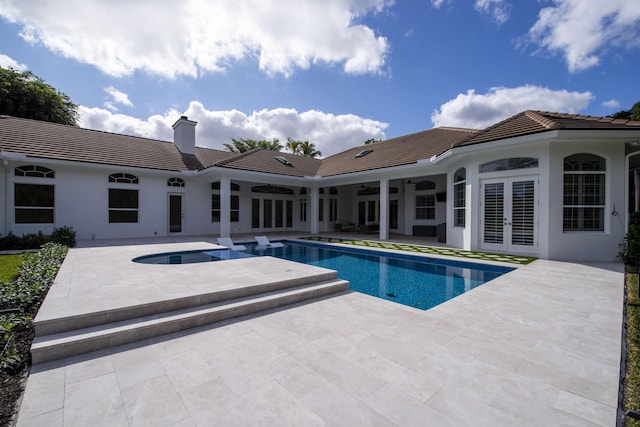 view of swimming pool with an in ground hot tub, french doors, and a patio area