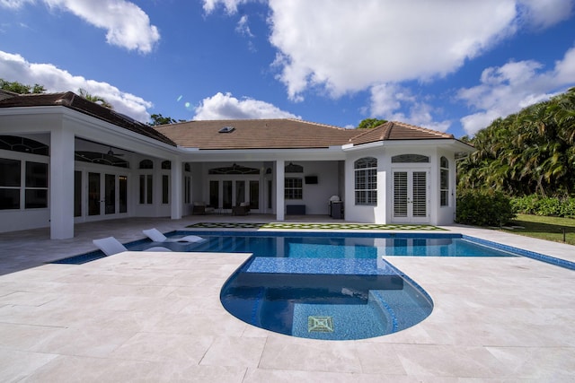 view of pool featuring ceiling fan, a patio area, an in ground hot tub, and french doors