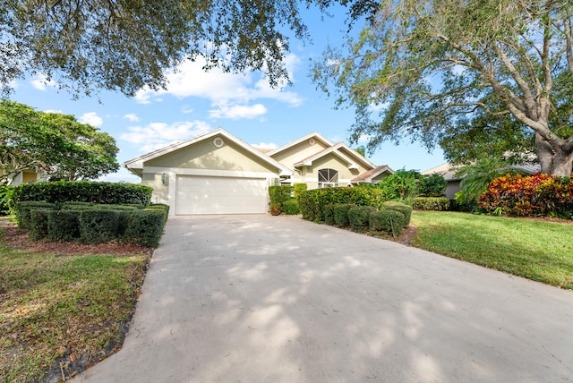 view of front of house with a garage and a front lawn