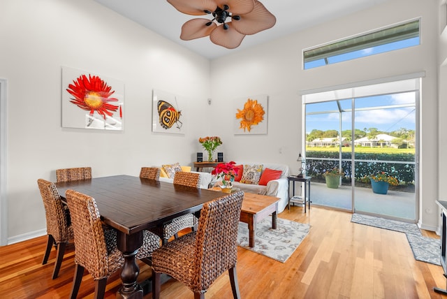 dining space with ceiling fan and light hardwood / wood-style flooring