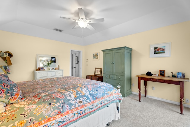 bedroom with light colored carpet, vaulted ceiling, and ceiling fan