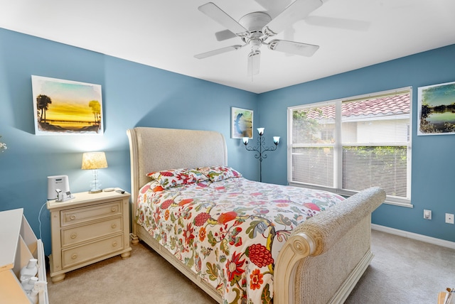 bedroom with ceiling fan and light carpet