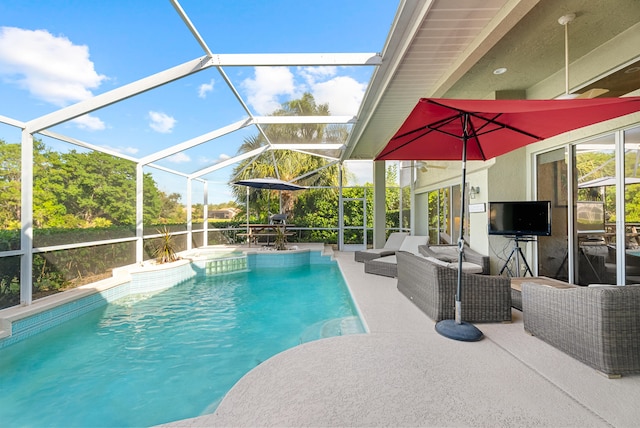 view of pool with glass enclosure, an outdoor living space, and a patio