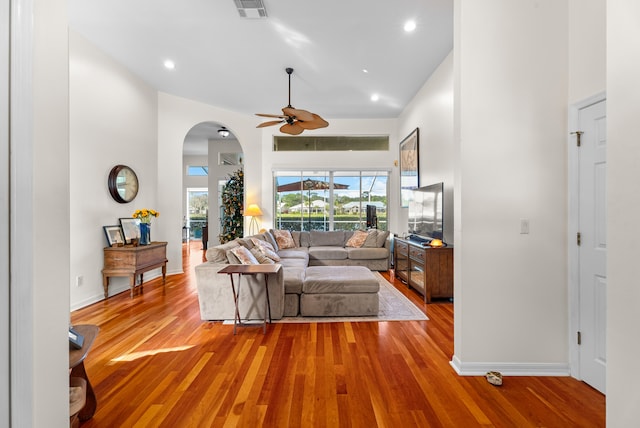 living room featuring light wood-type flooring, high vaulted ceiling, and ceiling fan