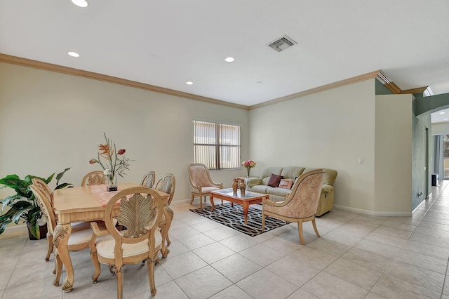 tiled dining room featuring crown molding