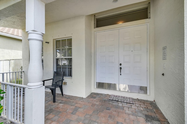 view of exterior entry with covered porch