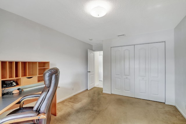 home office with light carpet and a textured ceiling