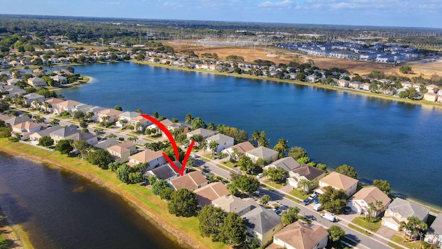 birds eye view of property with a water view